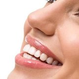 Close-up of a smiling face with white teeth