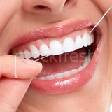 White teeth being flossed