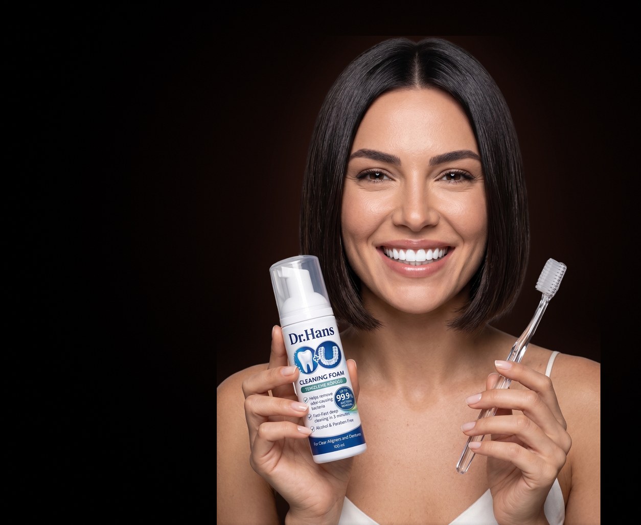 Smiling woman with Dr.Hans foam and a toothbrush