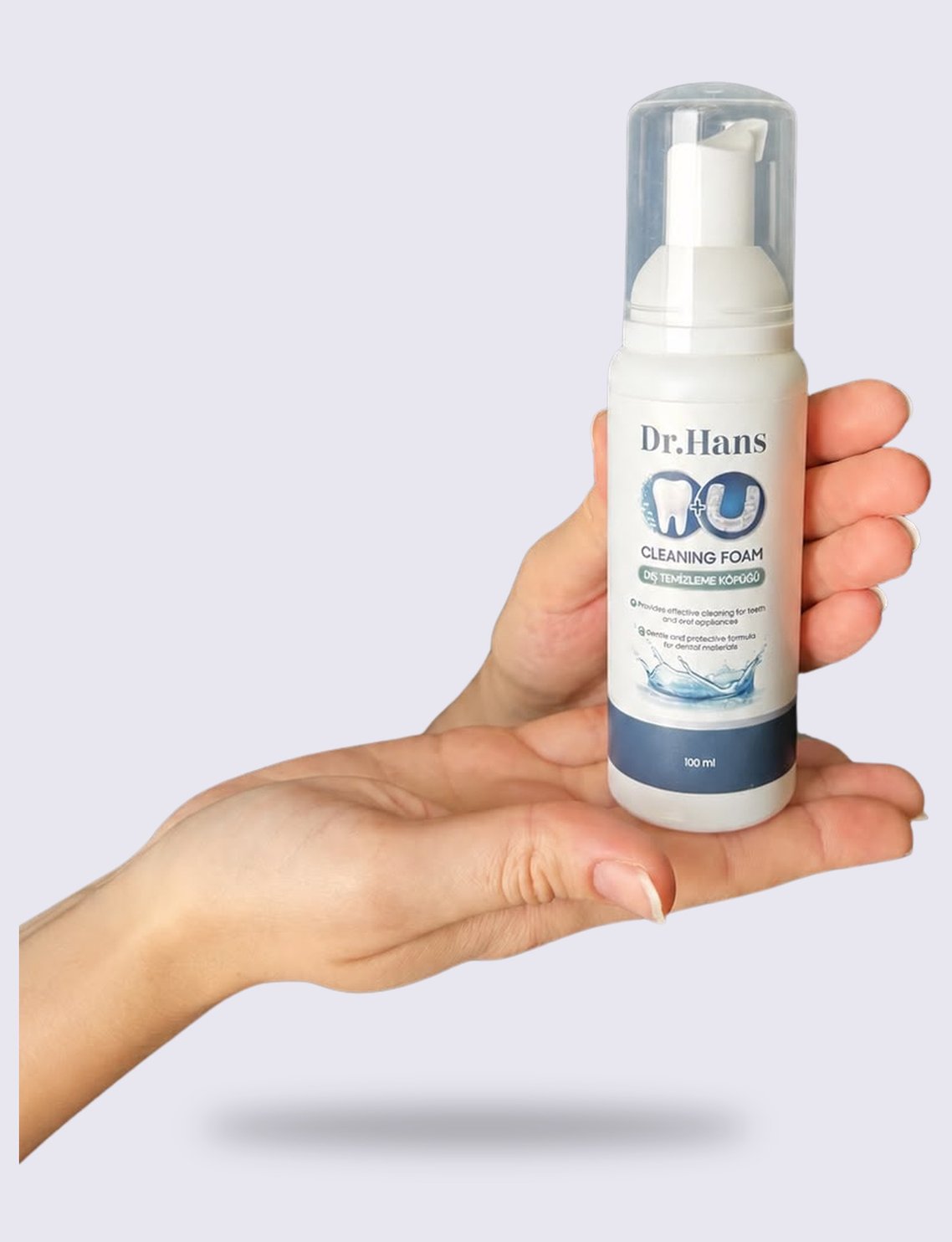 Hand holding a Dr.Hans Clean Foam bottle in the palm