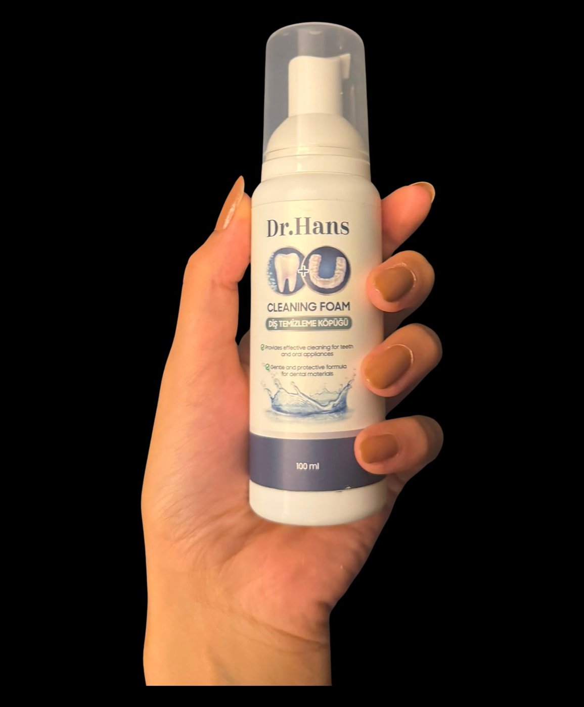 Hand holding a Dr.Hans Clean Foam bottle
