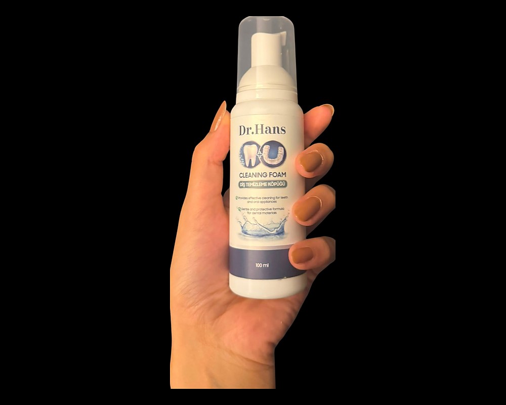 Hand gripping a Dr.Hans Clean Foam bottle