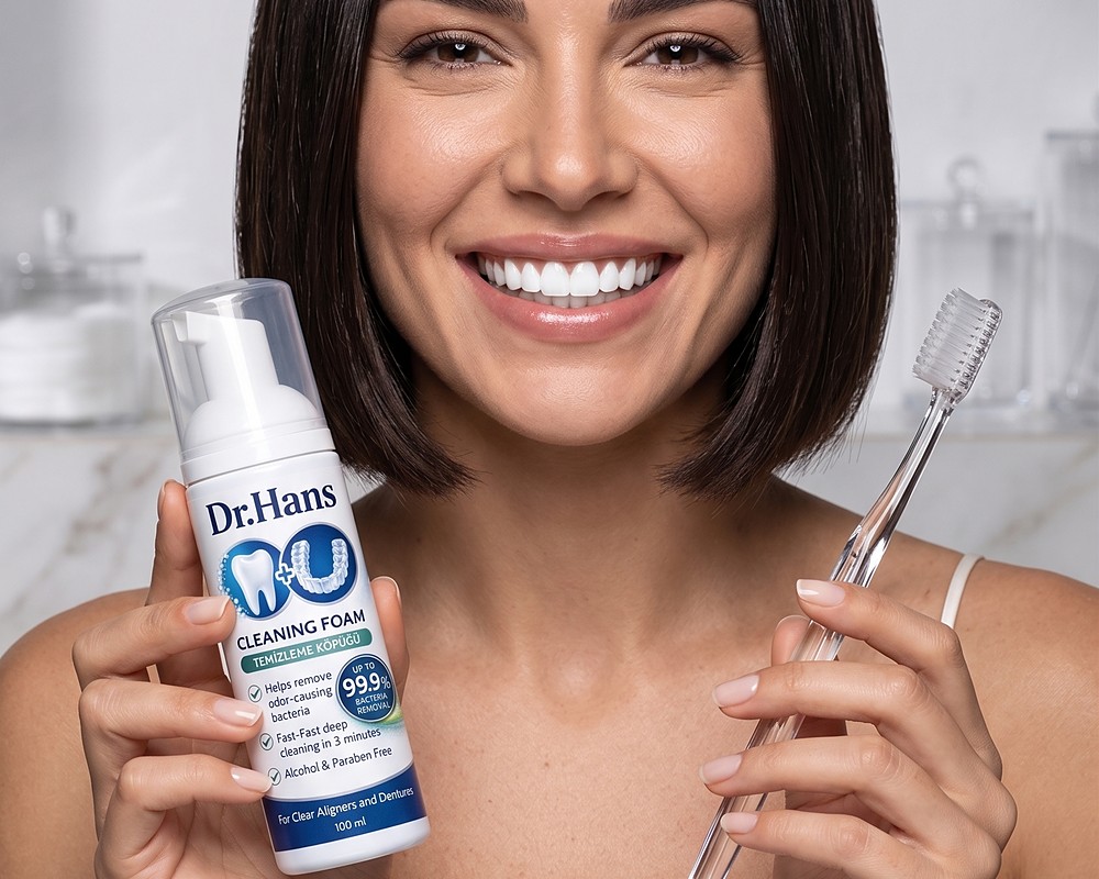 Smiling woman holding Dr.Hans foam and a toothbrush